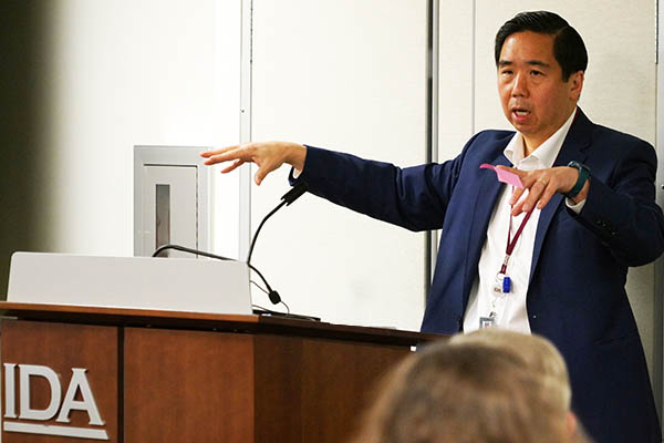 Photo of presenter presenting slides to small audience